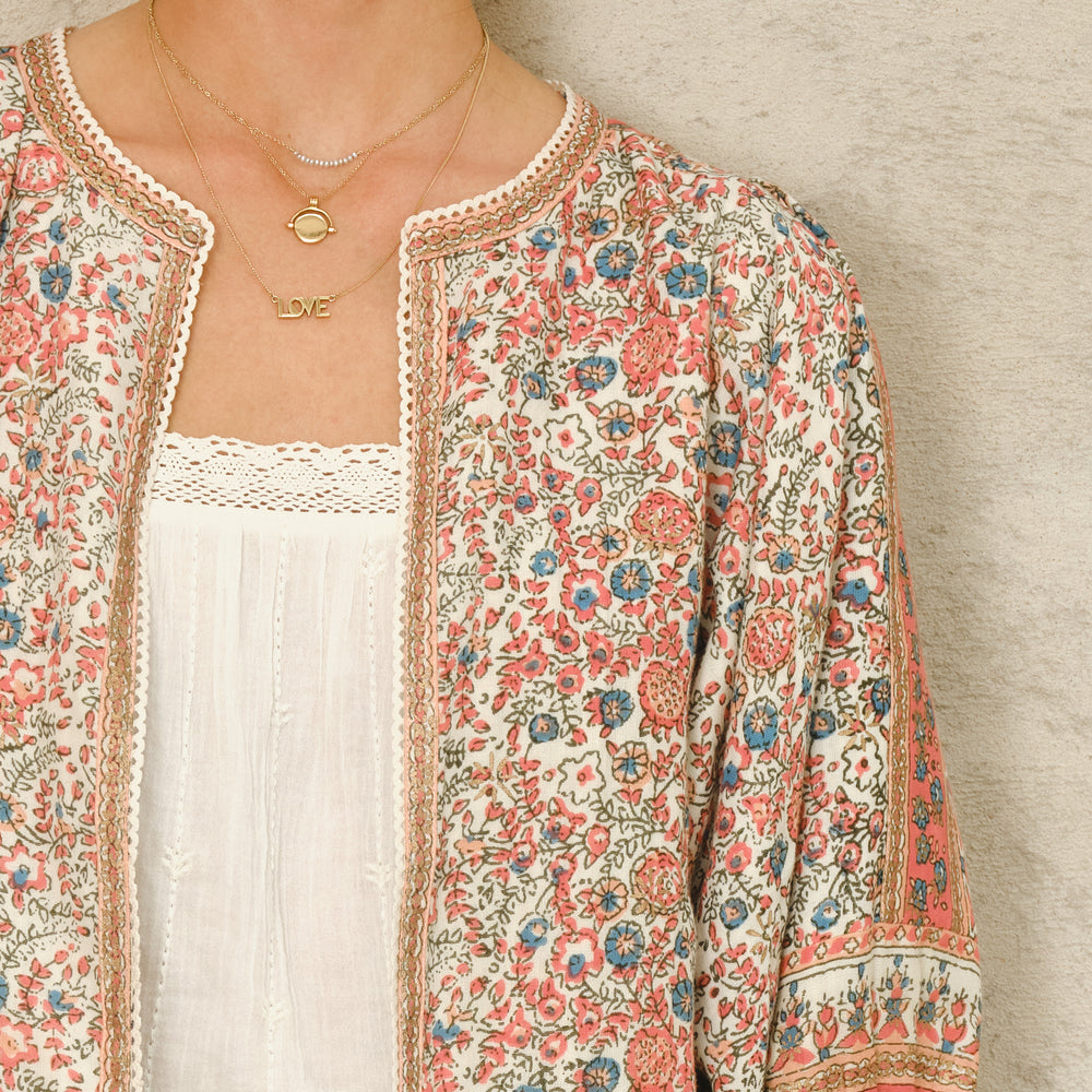 Floral and border detail printed cotton jacket with gathered 3/4 sleeves
Woven striped cotton lining
Side slip pockets
Cotton lace trim detail

Fits true to size. Relaxed, comfortable fit with wide arm opening. Model is 5'9" and wearing a size S.

Hand wash only.