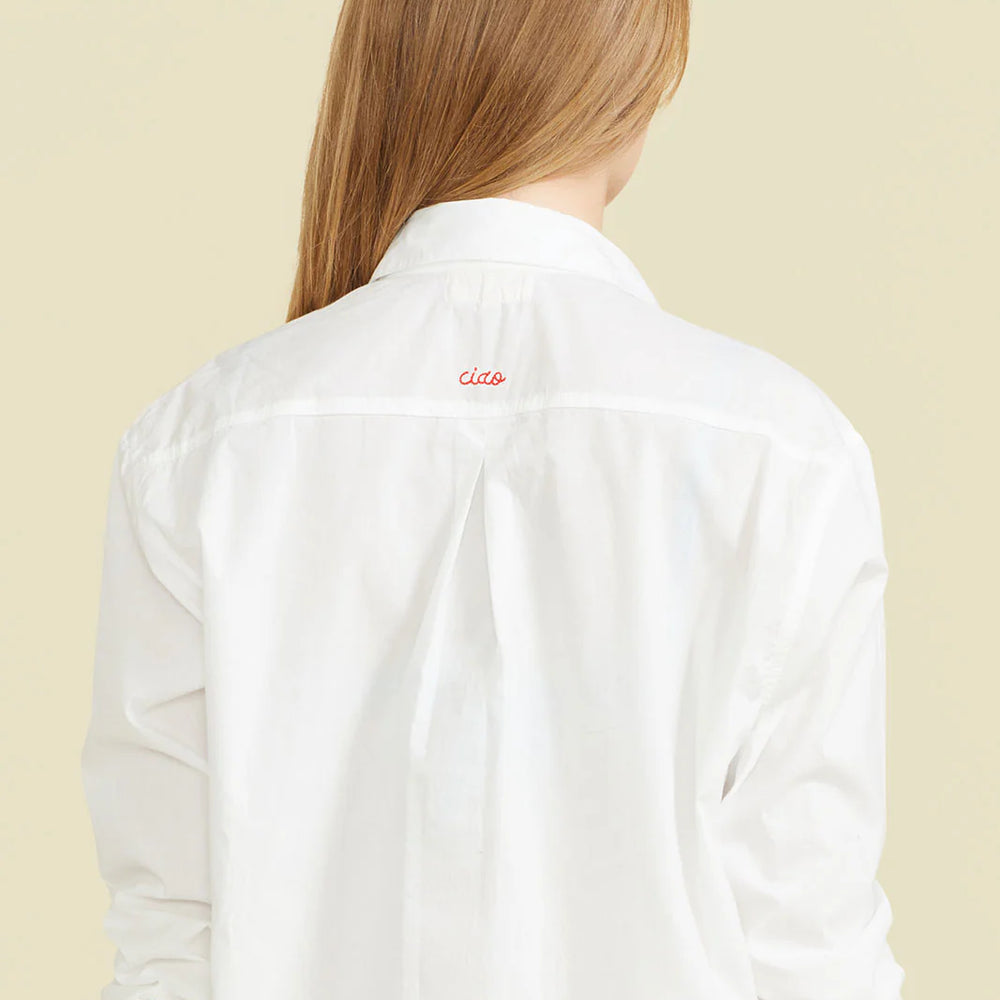 
                  
                    Made in a crisp white cotton fabric, the Ciao Shirt Dress is the perfect oversized, classic button-down with a special embroidered "Ciao" detail on the back. The carefully placed buttons on the cuff and the extra length in the back to provide more coverage prove that our signature shirt dress is a cover-up

                  
                