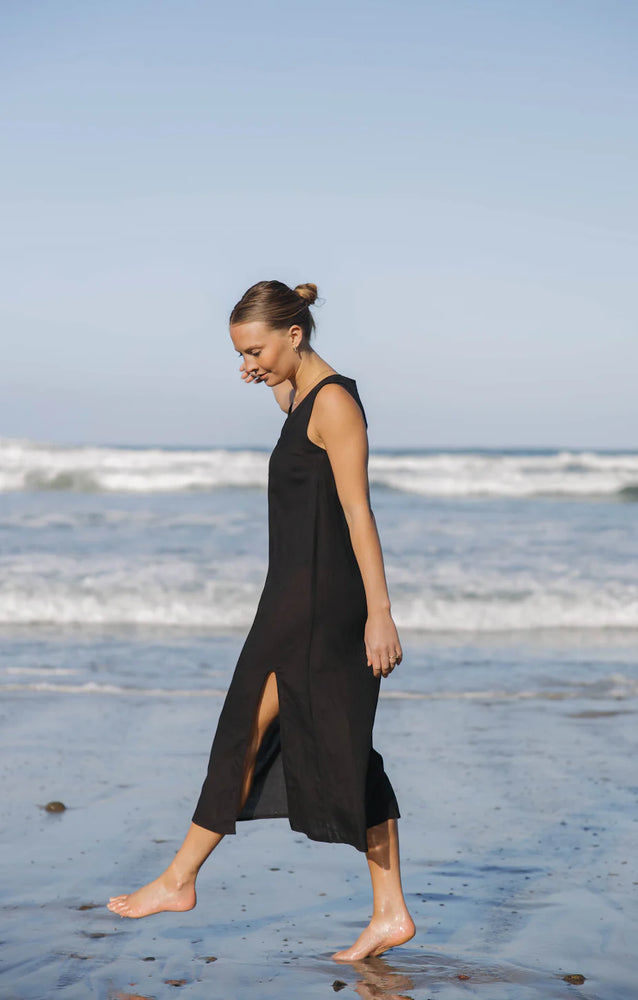 
                  
                    One of our most versatile pieces! Cut from a cotton, viscose, blend, the Grotta Midi Dress is A-line dress with a relaxed silhouette, a deep v-neckline, and one high slit in the front for an elevated feminine look. Paired with your favorite swimsuit, the Grotta Midi Dress is perfect for the pool, beach, and beyond. 


                  
                
